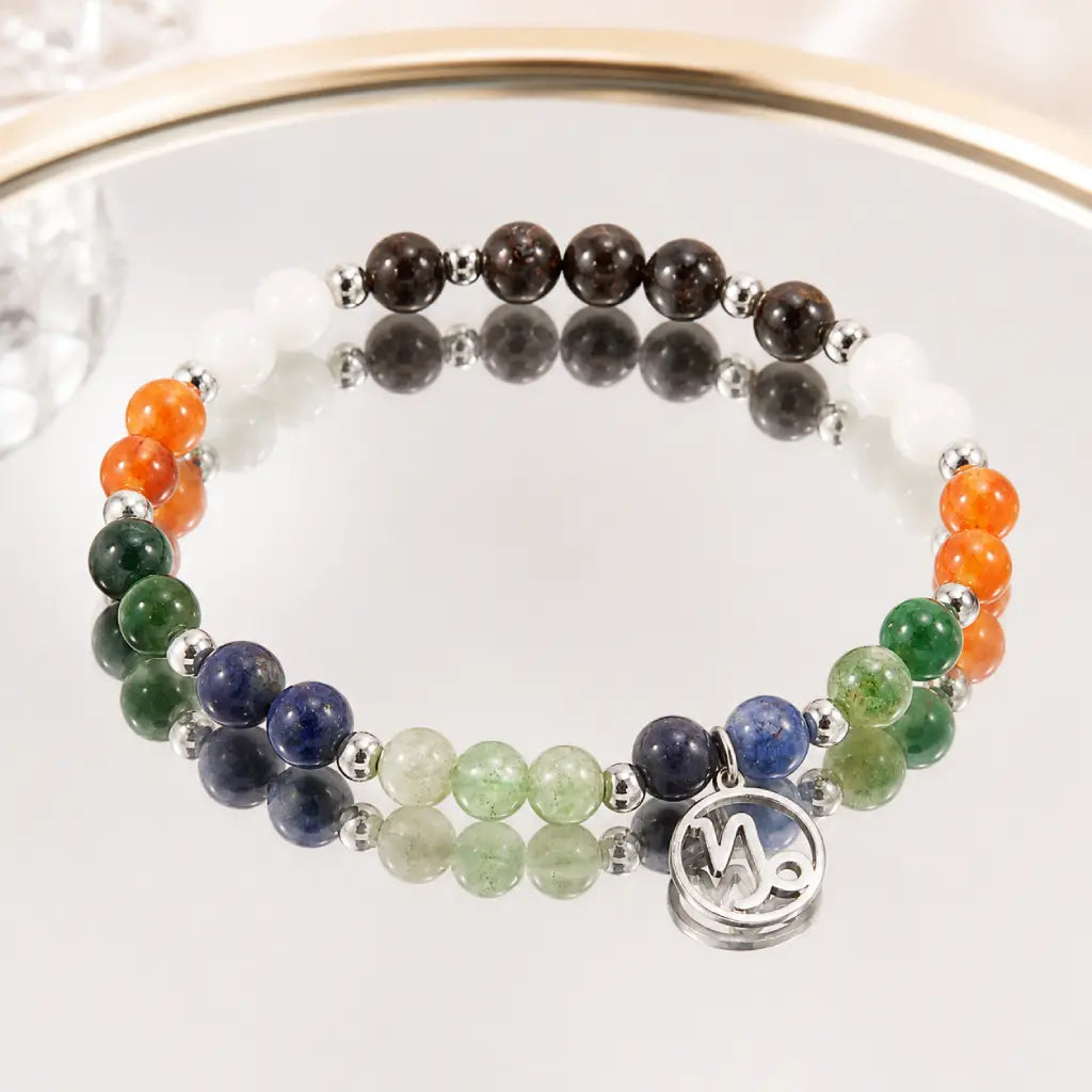 Capricorn zodiac gemstone bracelet reflected on a mirror surface showcasing premium crystal bead details and elegance.