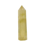 Citrine crystal tower shown alone, on a white backdrop, with pale yellow color, a flat base, six polished sides, a faceted point, and soft cloudy patterns inside the stone in view.