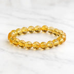 Citrine jewelry displayed on marble surface with faceted crystal bracelet for sophisticated beauty
