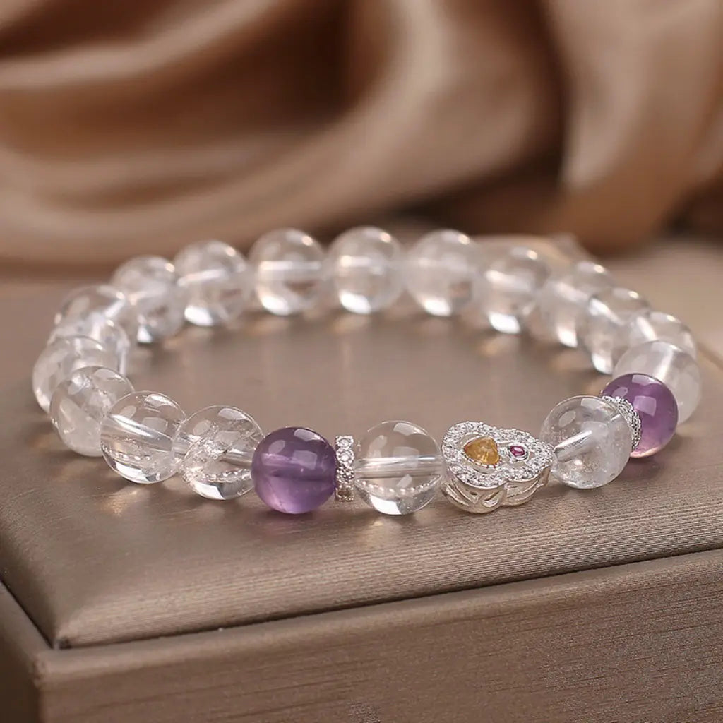 Crystal bead bracelet featuring amethyst accents and transparent gemstones for stylish healing energy wear