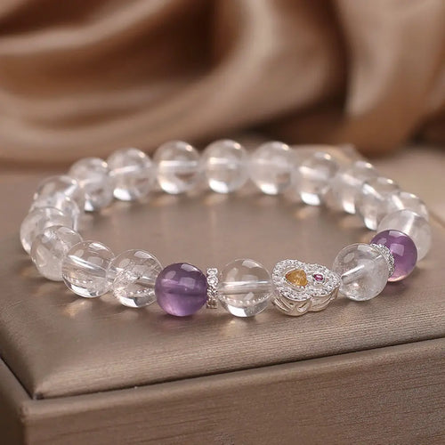 Crystal bead bracelet featuring amethyst accents and transparent gemstones for stylish healing energy wear