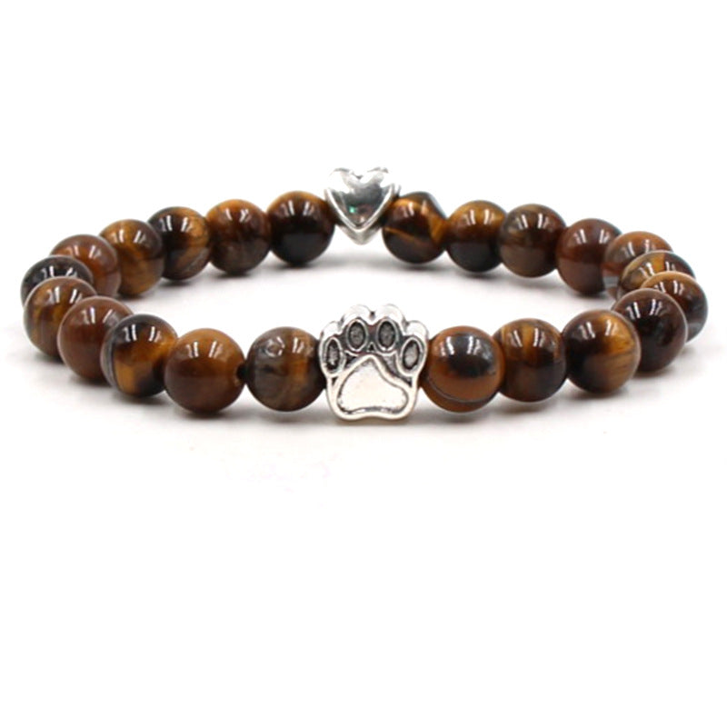 Dog paw stone bracelet with golden-brown tiger eye beads, showing 8 mm round beads, a silver-color paw-print charm, a heart accent, and a circular unisex design on a white display.