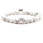 Dog paw stone bracelet with white marbled beads, showing 8 mm round beads, a silver-color paw-print charm, a heart accent, and a circular unisex design on a clean white background.