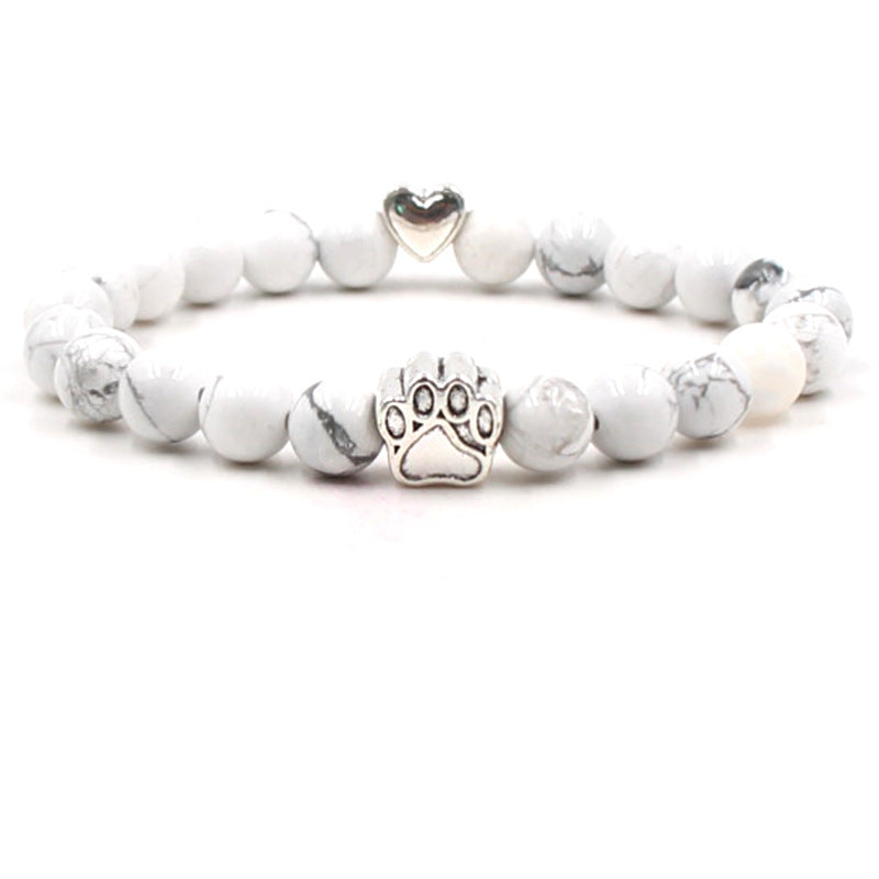 Dog paw stone bracelet with white marbled beads, showing 8 mm round beads, a silver-color paw-print charm, a heart accent, and a circular unisex design on a clean white background.