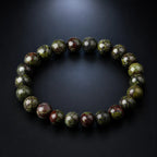 Dragon blood stone bracelet on charcoal background, polished green red jasper healing crystal protection bracelet