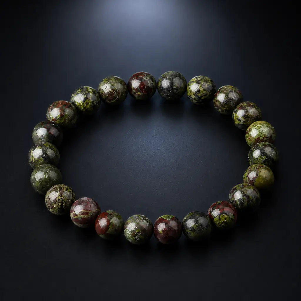 Dragon blood stone bracelet on charcoal background, polished green red jasper healing crystal protection bracelet