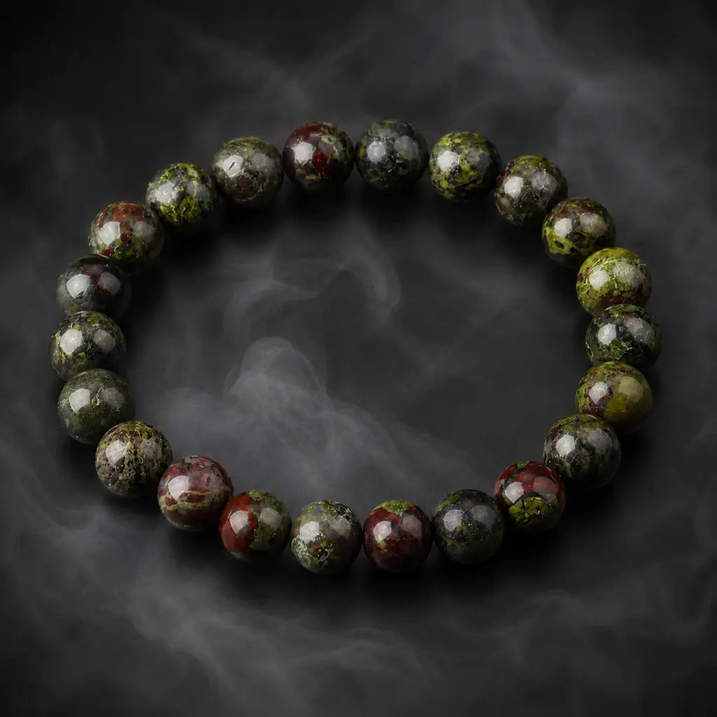 Dragon blood stone bracelet on smoky dark background, green red speckled jasper healing protection bracelet