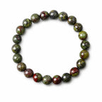 Dragon blood stone bracelet on white background, green red natural gemstone healing crystal stretch bracelet