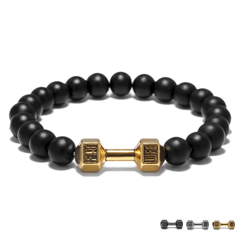 Dumbbell bracelet with matte black agate beads and a gold-tone FIT LIFT centerpiece, seen in a neat front-facing circle on white for a clear view of the full elastic beaded design.
