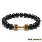Dumbbell bracelet with matte black agate beads and a gold-tone FIT LIFT centerpiece, seen in a neat front-facing circle on white for a clear view of the full elastic beaded design.