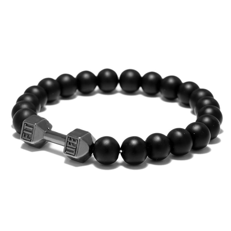 Dumbbell bracelet in an angled view with matte black agate beads and a gun-black FIT LIFT centerpiece, showing the round bead shape and flexible full elastic construction on white.
