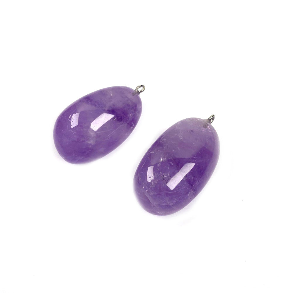 Freeform amethyst pendant pair with smooth polished purple surfaces, varied rounded shapes, visible internal color bands, and tiny silver-color hanging loops on a white background.