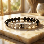 Gemini bracelet on golden marble with black onyx, white howlite, and silver zodiac charm for premium polished gifting