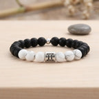 Gemini bracelet on wood display with black onyx, white howlite, and silver twins charm for thoughtful zodiac gift