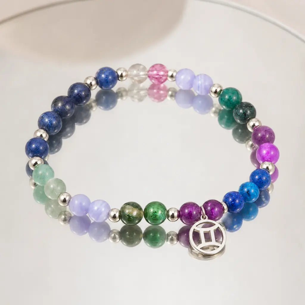 Gemini zodiac beaded bracelet reflected on mirror surface. Best healing stone jewelry with Gemini symbol charm. Perfect astrology gift for June birthdays.
