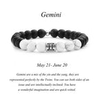 Gemini zodiac bracelet with matte black Agate and white Howlite beads and a silver Gemini twin charm on white background