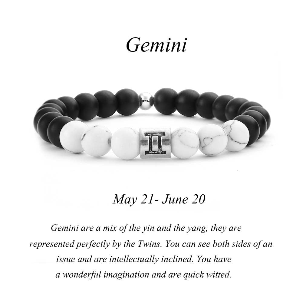 Gemini zodiac bracelet with matte black Agate and white Howlite beads and a silver Gemini twin charm on white background