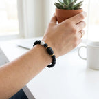 Gemini Zodiac Bracelet worn on wrist with black beads and white stone, trendy astrology jewelry for everyday confidence and style