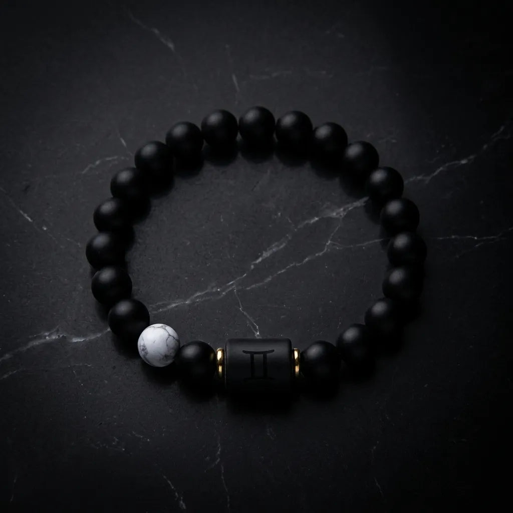 Gemini Zodiac Bracelet on dark marble background with matte beads, luxury astrology jewelry designed for bold style and energy balance