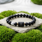 Gemini Zodiac Bracelet on stone with green grass background, black bead astrology jewelry for fresh outdoor style and everyday wear