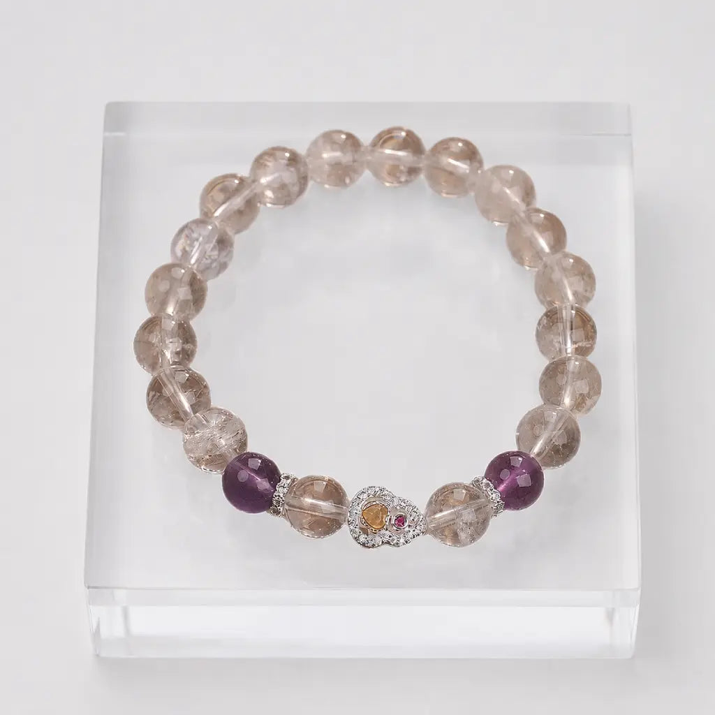 Amethyst crystal bracelet with polished gemstone beads and decorative heart charm for modern elegance