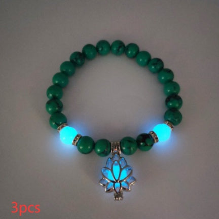 Glow in the dark lotus bracelet three-piece green stone set with a blue glow, with 8 mm real-stone beads, elastic fit, a silver-color lotus, and light-charged accents in low light.