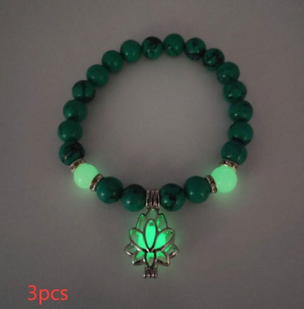 Glow in the dark lotus bracelet three-piece green stone set with green glow, with 8 mm real-stone beads, elastic fit, a silver-color lotus, and light-charged accents in a dim room.