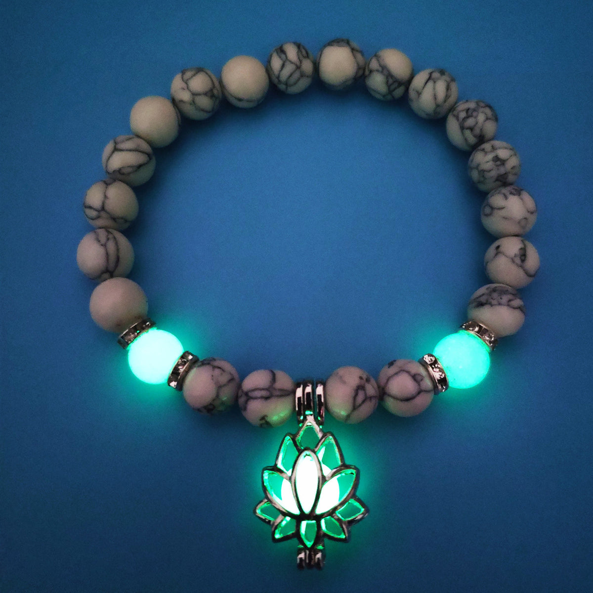 Glow in the dark lotus bracelet pale marbled beads with a green glow view, with 8 mm real-stone beads, elastic fit, a silver-color lotus, and light-charged accents for daily style.