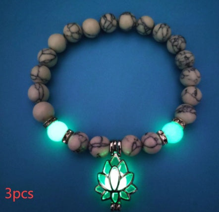 Glow in the dark lotus bracelet three-piece pale marbled set with green glow, with 8 mm real-stone beads, elastic fit, a silver-color lotus, and light-charged accents in low light.