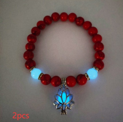 Glow in the dark lotus bracelet two-piece red stone set with a blue glow, with 8 mm real-stone beads, elastic fit, a silver-color lotus, and light-charged accents shown after dark.