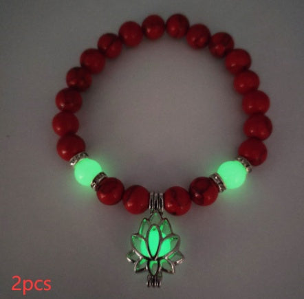 Glow in the dark lotus bracelet two-piece red stone set with green glow, with 8 mm real-stone beads, elastic fit, a silver-color lotus, and light-charged accents for day and night.
