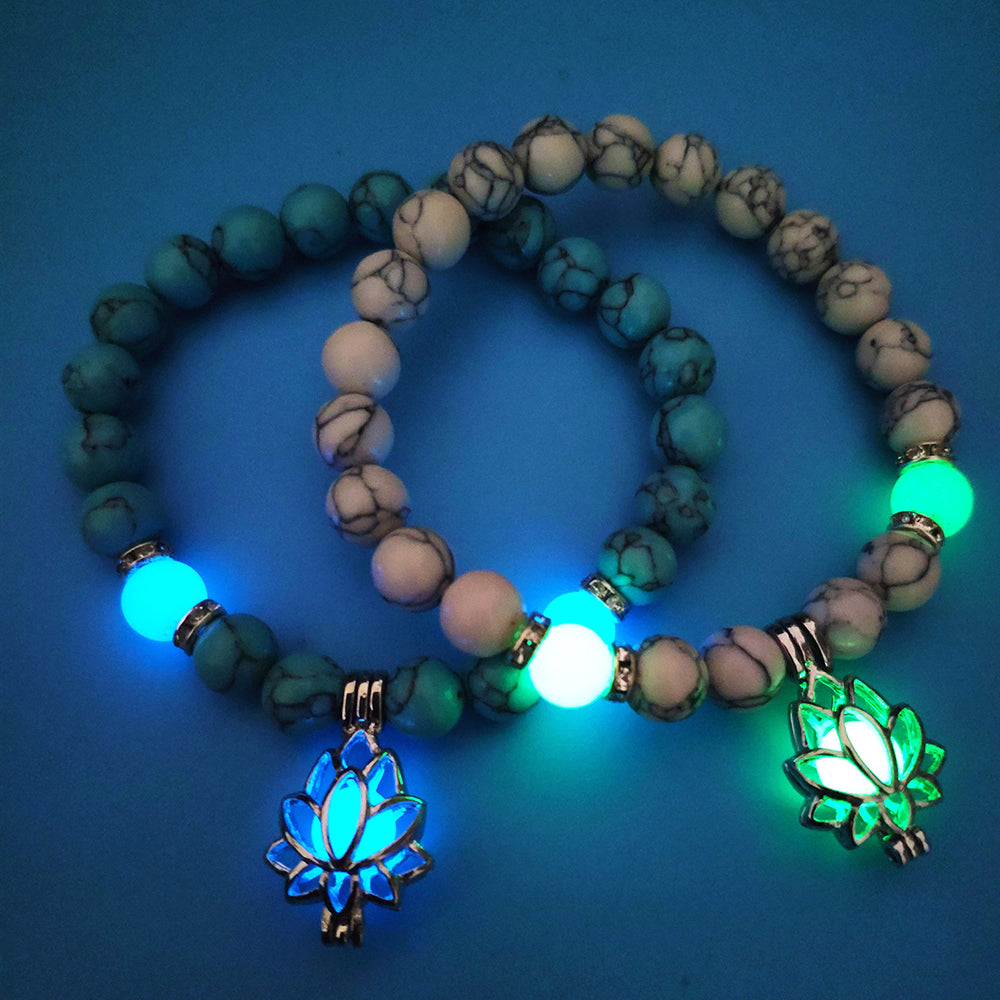 Glow in the dark lotus bracelet two blue-green and pale stone styles glowing, with 8 mm real-stone beads, elastic fit, a silver-color lotus, and light-charged accents in low light.