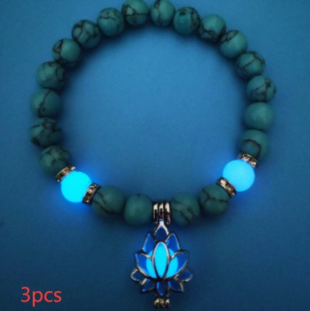 Glow in the dark lotus bracelet three-piece blue-green set with a blue glow, with 8 mm real-stone beads, elastic fit, a silver-color lotus, and light-charged accents in a dim room.