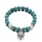 Glow in the dark lotus bracelet blue-green stone bracelet on a white background, with 8 mm real-stone beads, elastic fit, a silver-color lotus, and light-charged accents for night.