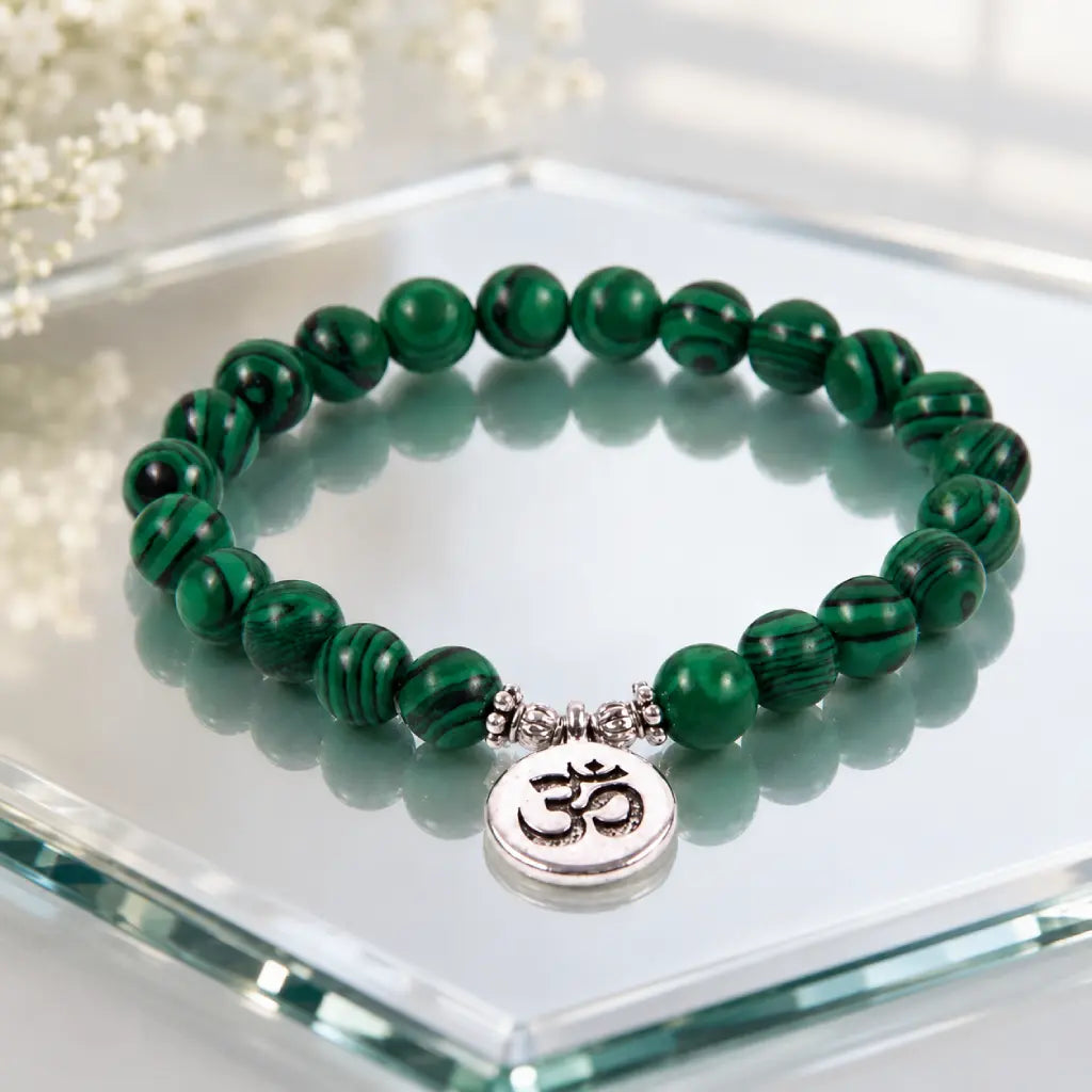 Green tigereye natural stone bracelet featuring glossy beads and silver Om charm with elegant reflection