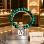 Green tigereye Buddha bracelet on acrylic stand in luxury jewelry boutique, spiritual stone charm bracelet gift
