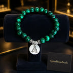 Green tigereye Buddha bracelet on navy velvet display roll with QuietMoonBeads brand card, yoga jewelry gift