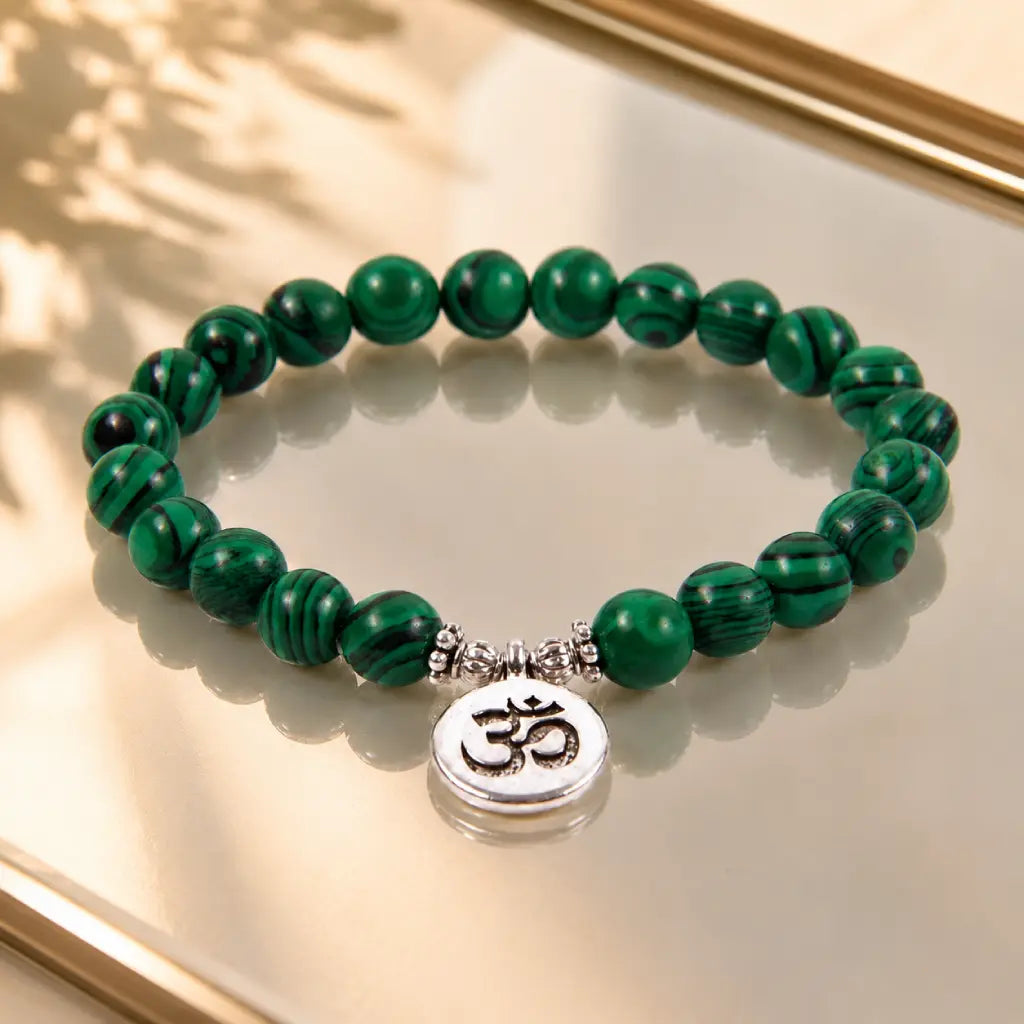 Green tigereye beaded bracelet with polished gemstone pattern and Om symbol for spiritual style