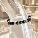 Green tigereye bracelet worn on wrist with glossy gemstone beads and healing crystal appeal for daily wear