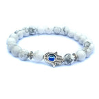 White Hamsa evil eye bracelet with marbled round natural-stone beads, silver-tone alloy spacers and a blue-eye hand centerpiece, photographed on clean, bright white background set.