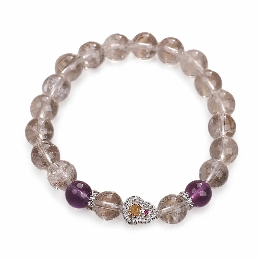 Gemstone bracelet featuring clear crystal beads and purple accents for elegant spiritual accessory styling