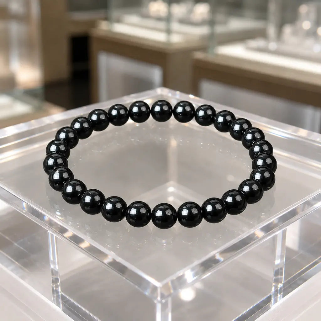 Hematite bracelet with shiny black gemstone beads on display showcasing healing crystal jewelry style