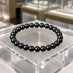 Hematite bracelet with shiny black gemstone beads on display showcasing healing crystal jewelry style