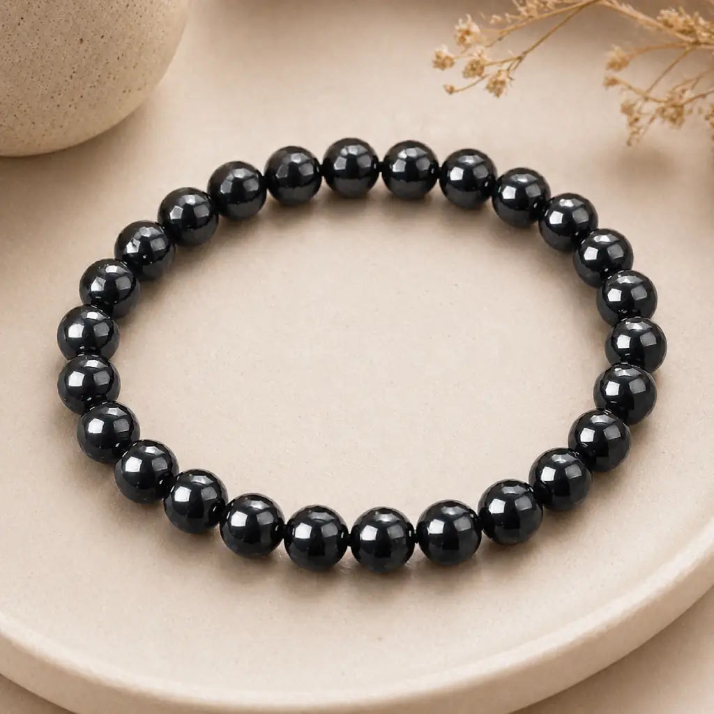 Hematite bracelet faceted black beads on stone plate emphasizing healing crystal jewelry for balance protection and elegant styling