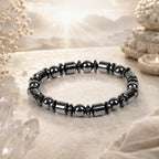 Hematite bracelet displayed beneath mystical lighting, healing crystal accessory for strong grounding energy