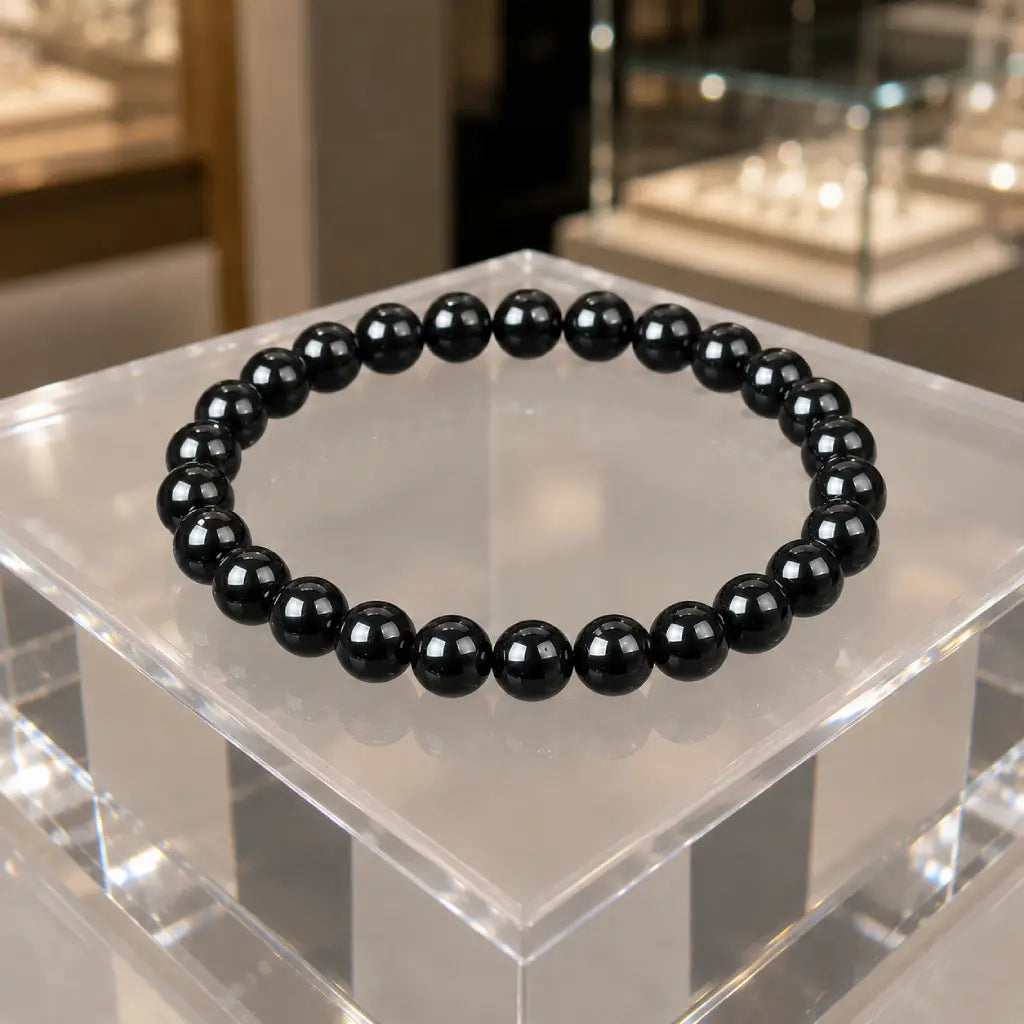 Hematite bracelet with polished black gemstone beads displayed elegantly as healing crystal jewelry for daily style