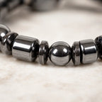 Hematite bracelet macro view with polished black stone beads, healing energy accessory for elegant style