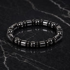 Hematite bracelet with premium black bead details on marble background showcasing timeless jewelry elegance