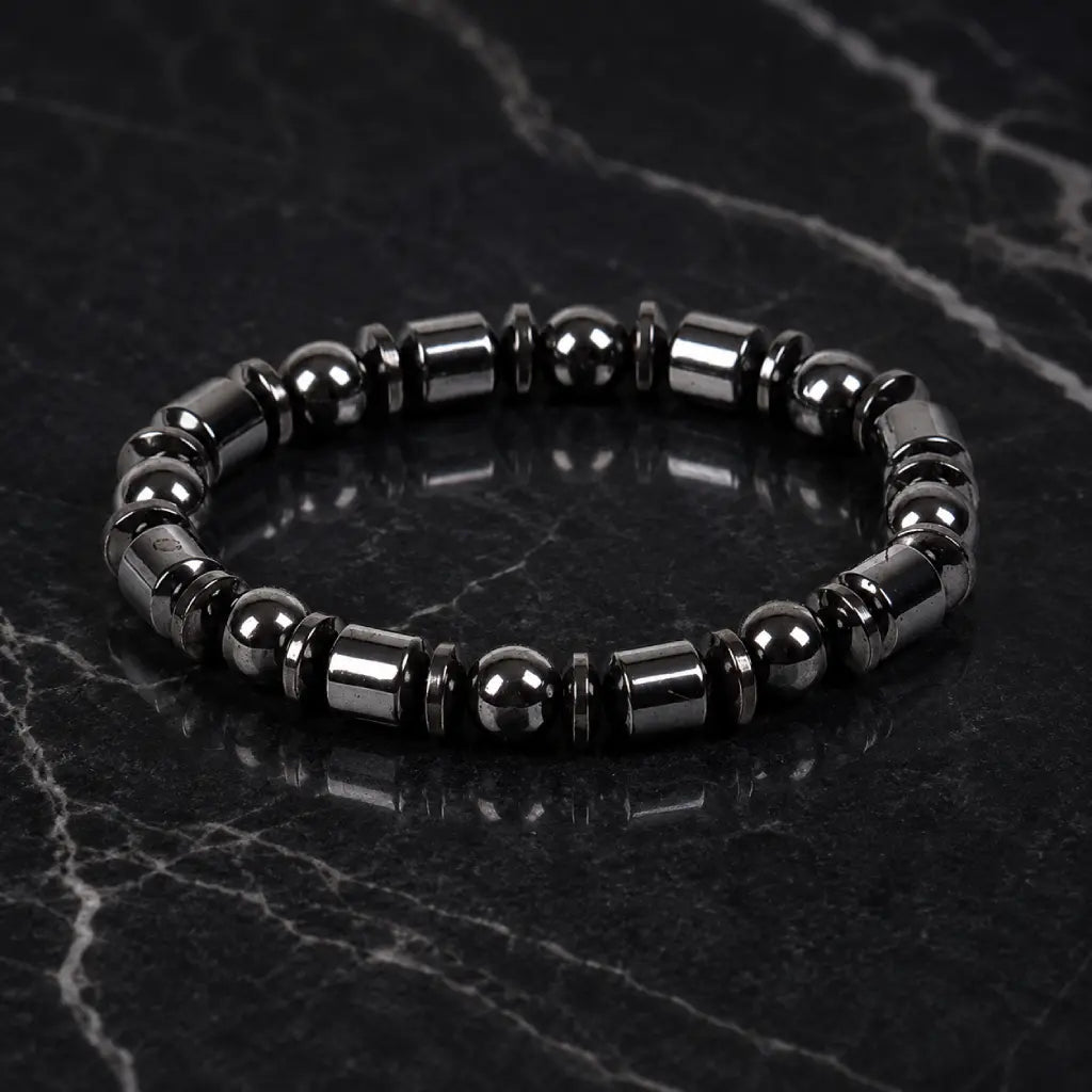 Hematite bracelet with premium black bead details on marble background showcasing timeless jewelry elegance