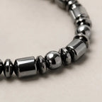 Hematite bracelet close-up showing reflective gemstone beads, grounding crystal jewelry with premium shine